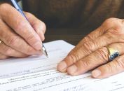 Person Signing Document Paper